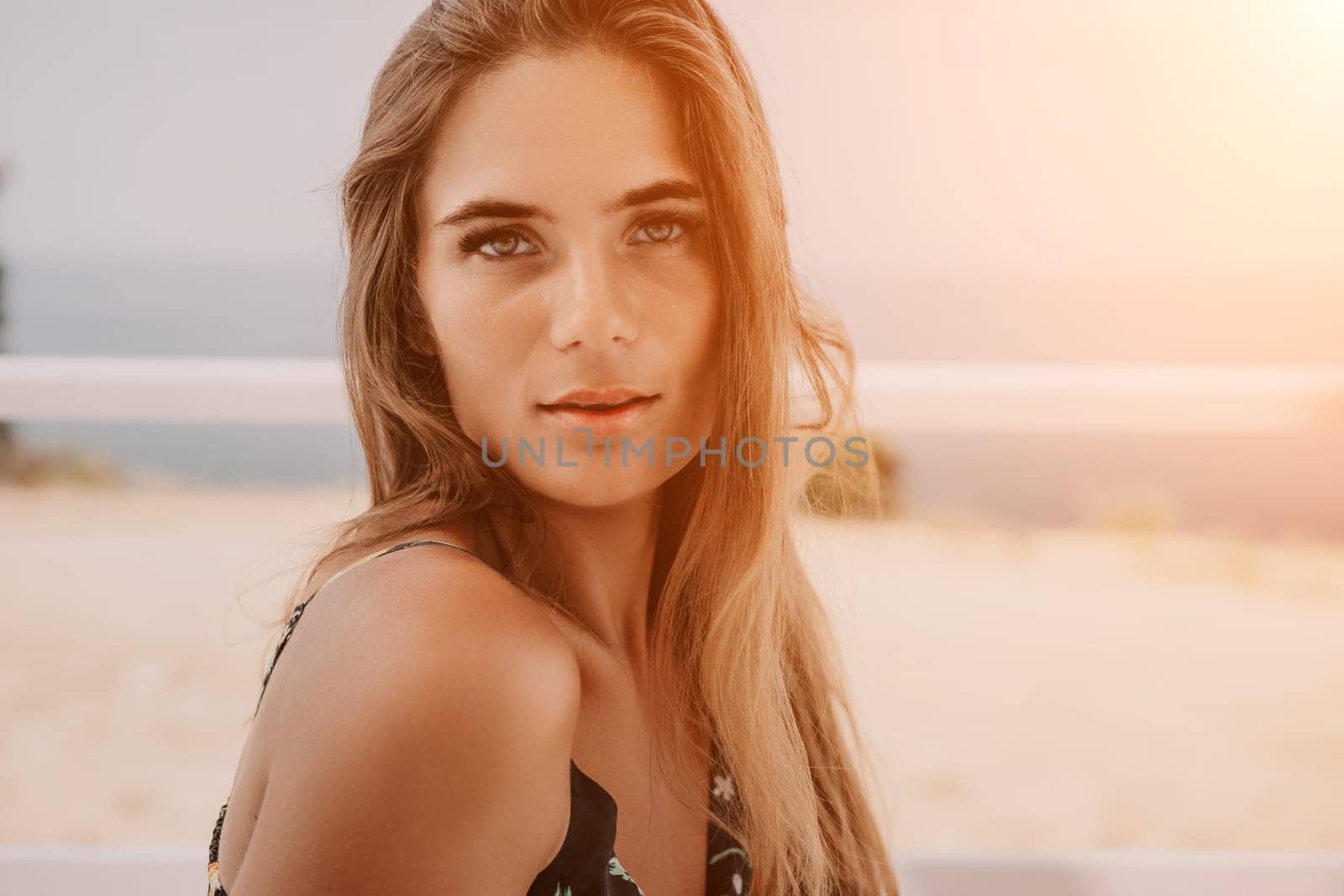 Happy woman portrait in cafe. Boho chic fashion style. Outdoor photo of young happy woman with long hair, sunny weather outdoors sitting in modern cafe