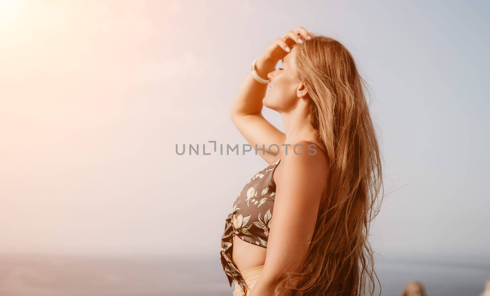 Woman travel sea. Happy tourist taking picture outdoors for memories. Woman traveler looks at the edge of the cliff on the sea bay of mountains, sharing travel adventure journey by panophotograph