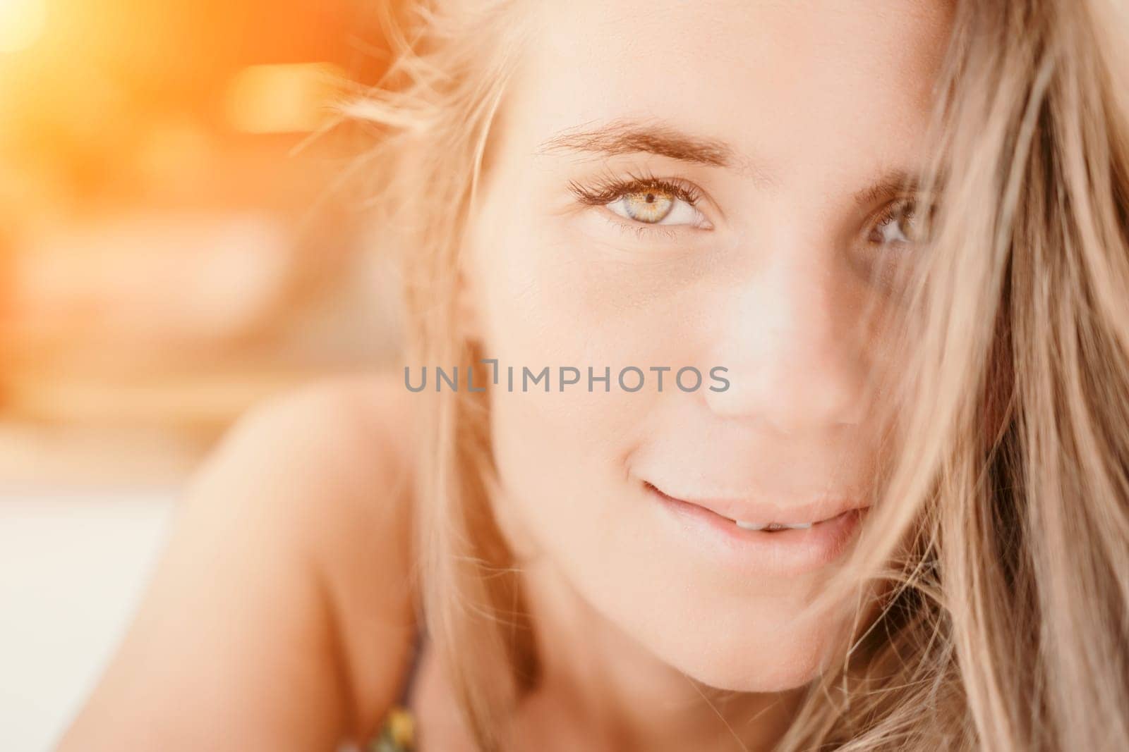 Happy woman portrait in cafe. Boho chic fashion style. Outdoor photo of young happy woman with long hair, sunny weather outdoors sitting in modern cafe