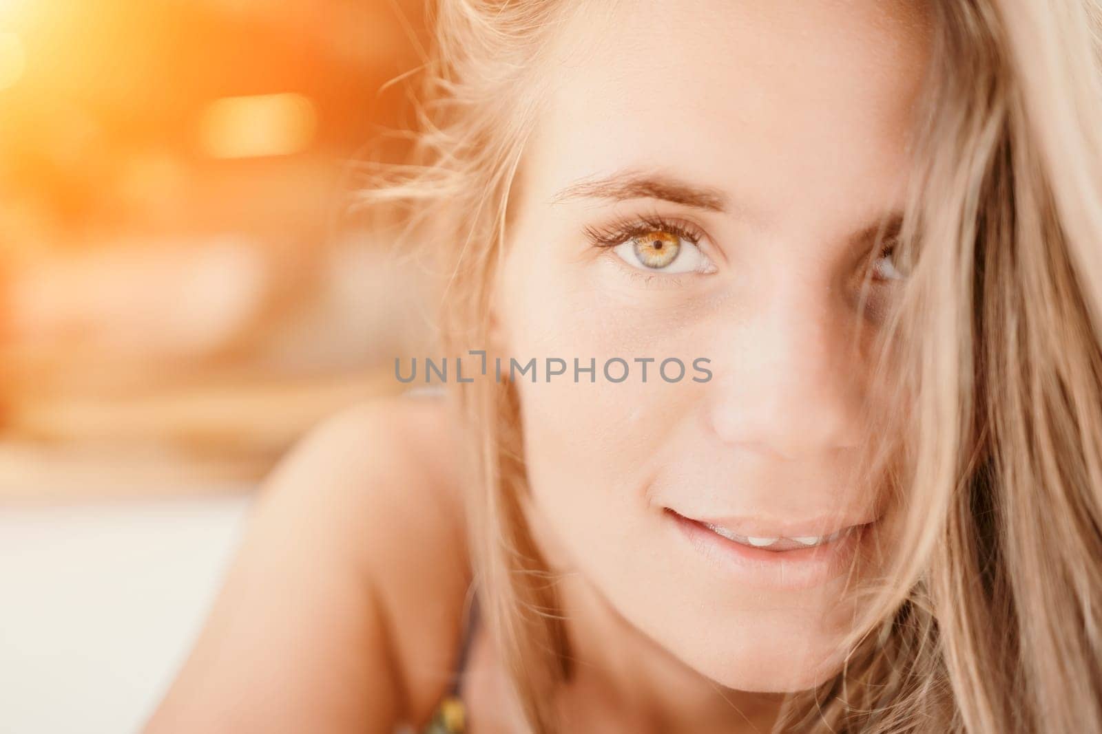 Happy woman portrait in cafe. Boho chic fashion style. Outdoor photo of young happy woman with long hair, sunny weather outdoors sitting in modern cafe