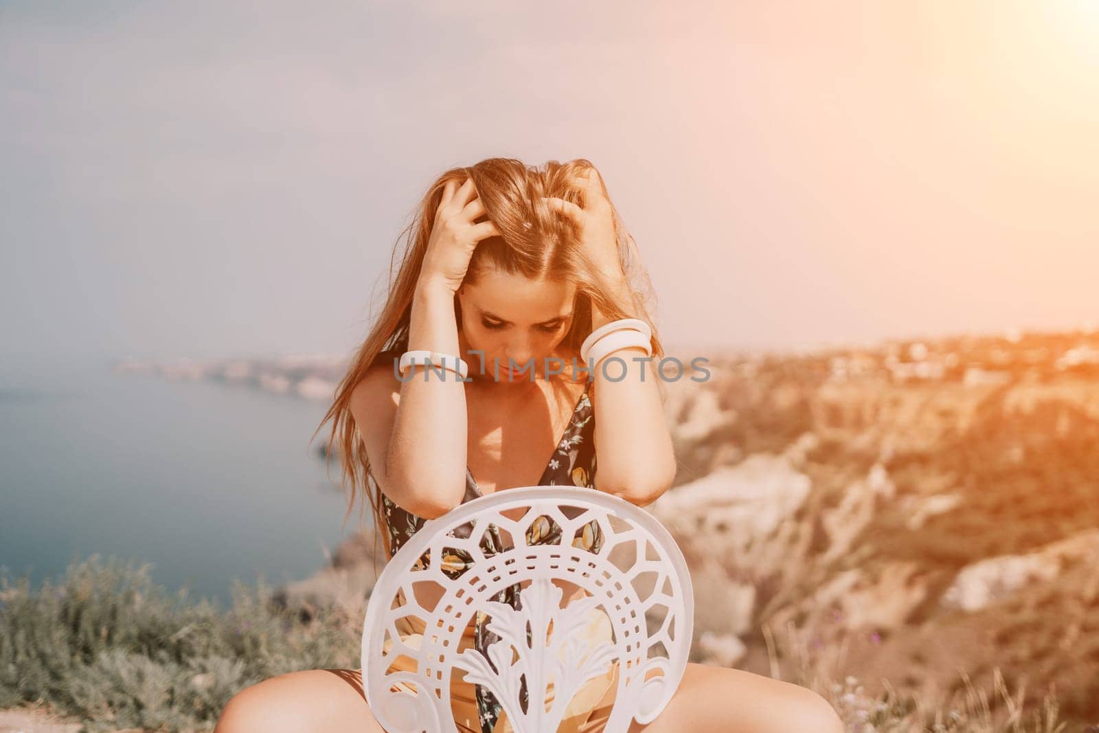 Happy woman portrait in cafe. Boho chic fashion style. Outdoor photo of young happy woman with long hair, sunny weather outdoors sitting in modern cafe