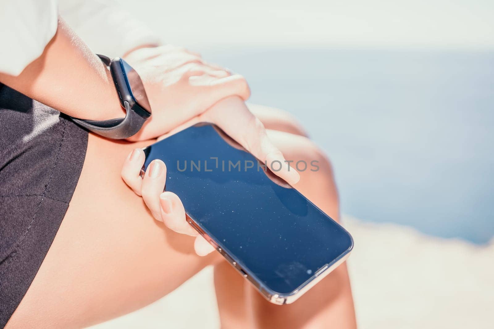 Happy girl doing yoga with laptop working at the beach. beautiful and calm business woman sitting with a laptop in a summer cafe in the lotus position meditating and relaxing. freelance girl remote work beach paradise