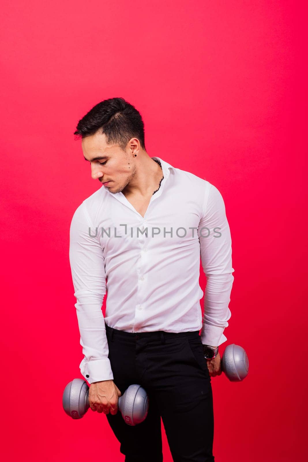 Business man with fitness dumbbells wear shirt. Studio shooting on red background by Zelenin