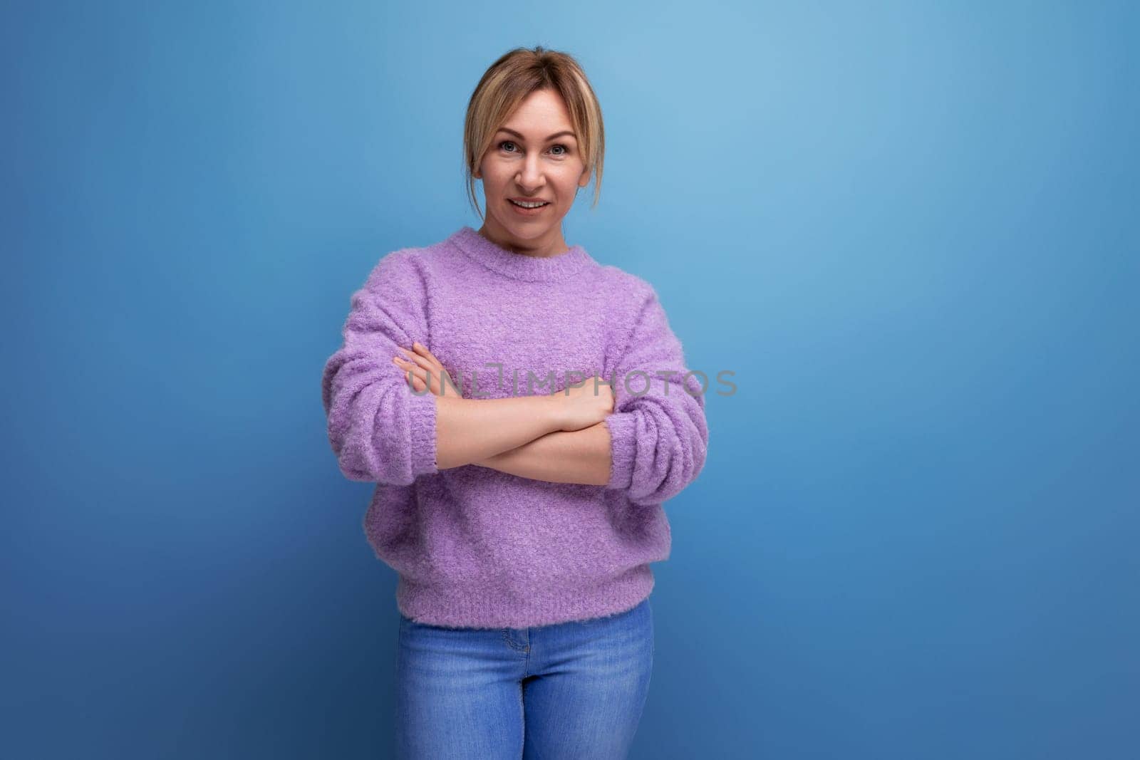 attractive confident blond young woman in a casual look with a good mood on a bright background with copy space.