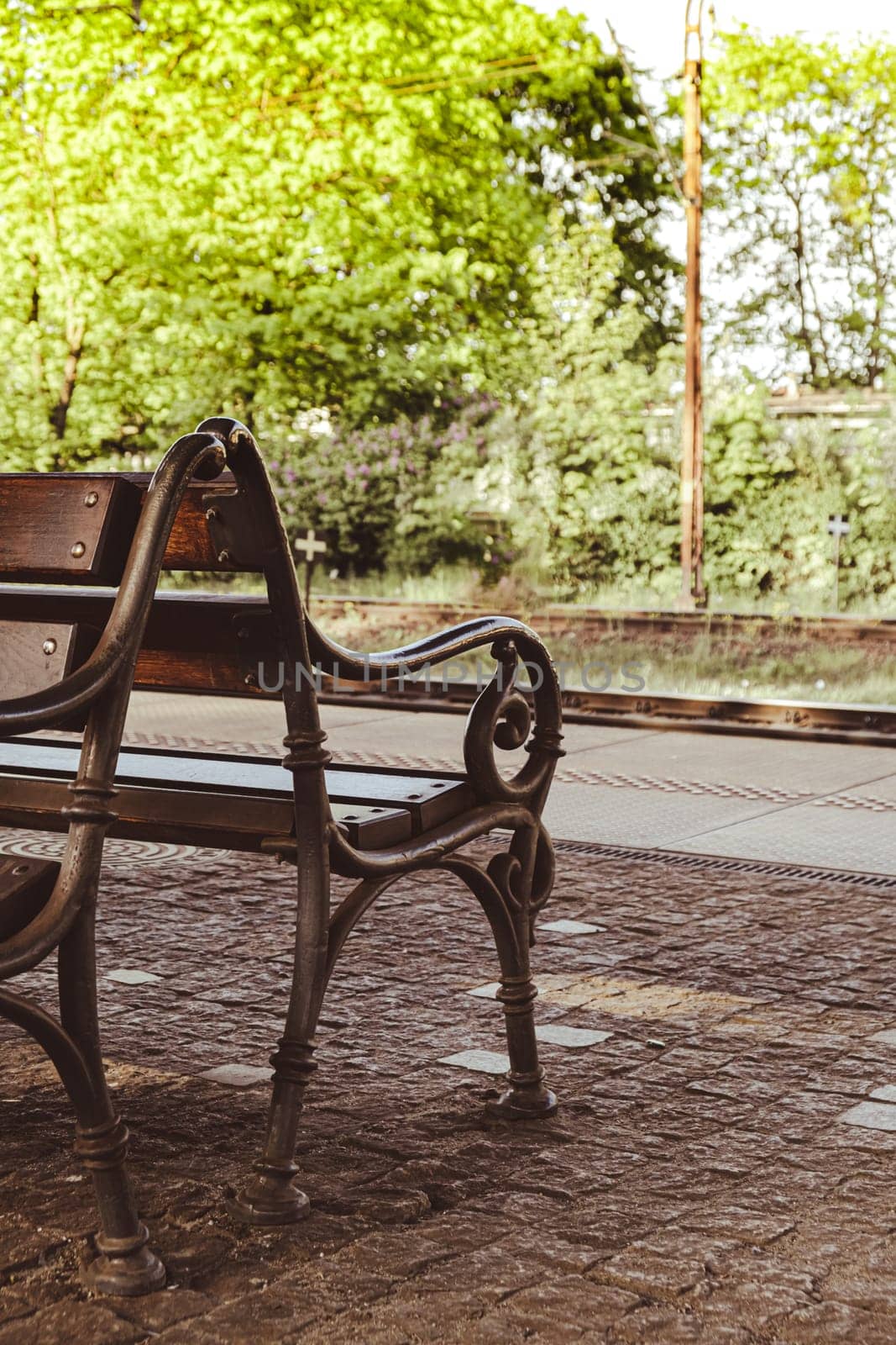 Railway station with empty bench. The way forward railway for train. Empty Railway track for locomotive. Transportation system Nature background around. travel tourist concept