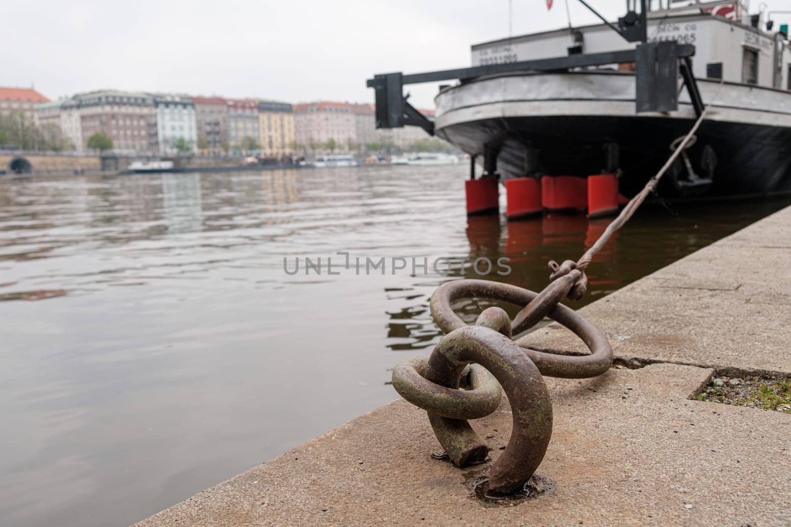 Ship or vessel moored on the embankment of the Vlatva river in Prague in cloudy and grey autumn day.