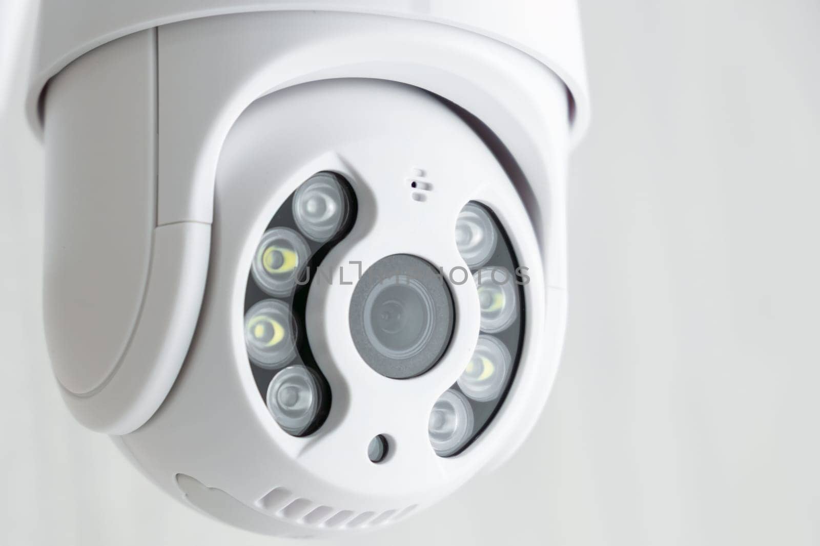 Security CCTV camera in office or shop building for protection against thieves, close up with copy space