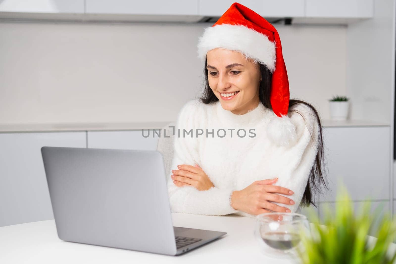 Freelancer working at home using her laptop during Christmas and New Year holidays.