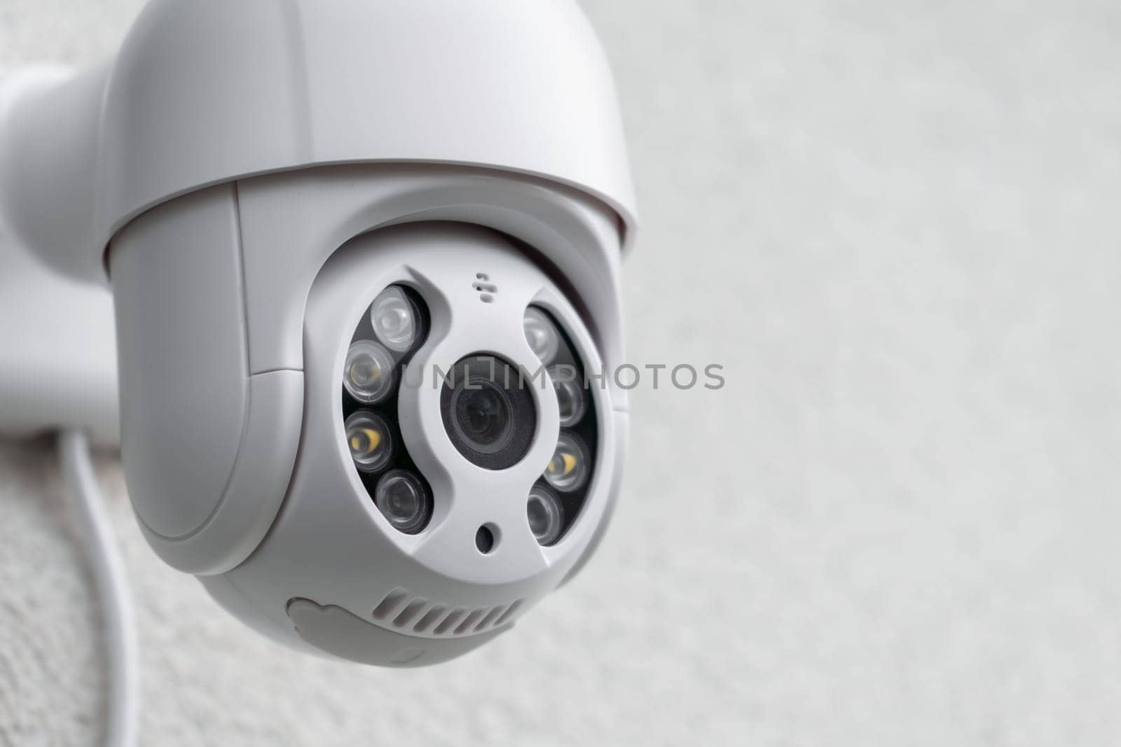 Security CCTV camera in office or shop building for protection against thieves, close up with copy space