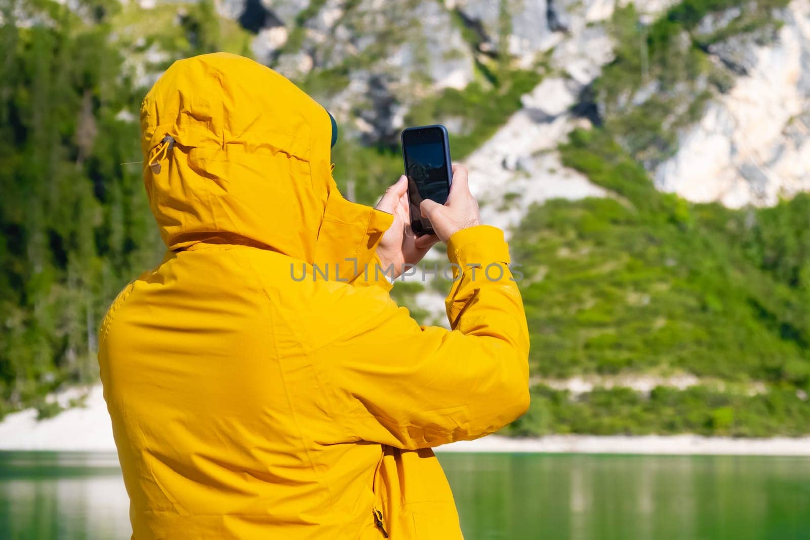 Travel blogger and tourist taking photo by smartphone of amazing landscape.