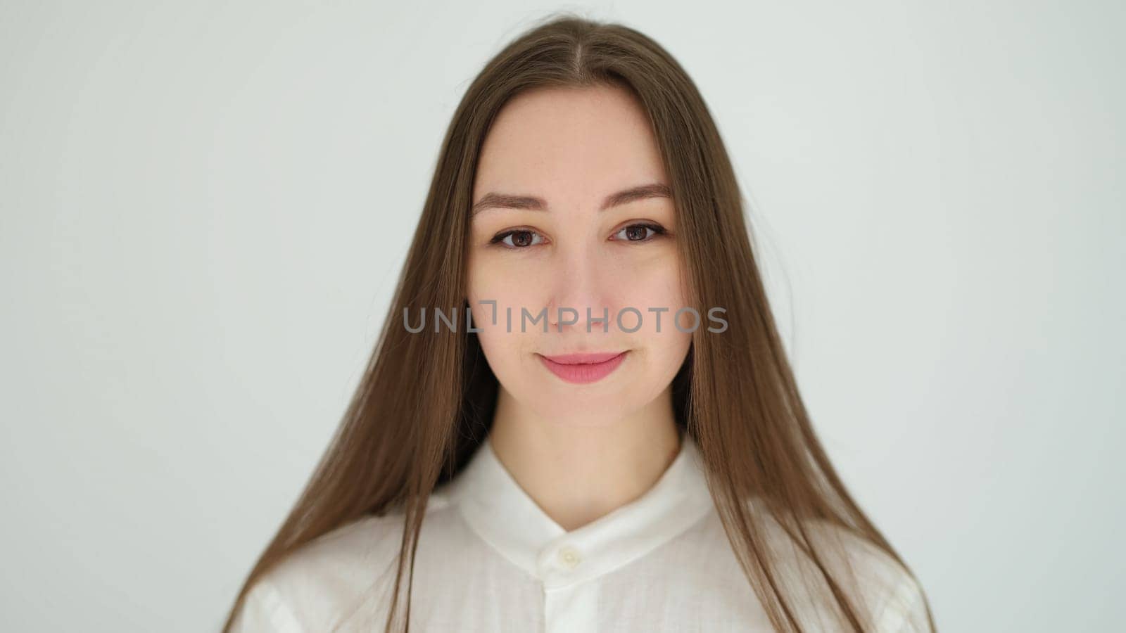 Portrait of young caucasian woman with long hair on white background by kuprevich