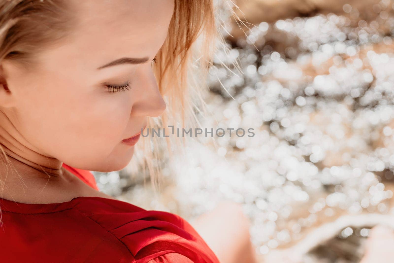 Woman summer travel sea. Happy tourist in long red dress enjoy taking picture outdoors for memories. Woman traveler posing on beach at sea surrounded by volcanic mountains, sharing travel adventure by panophotograph