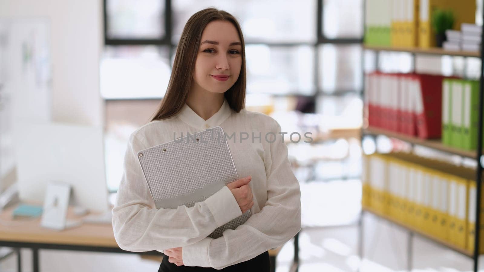 Portrait of successful businesswoman with documents in hands in office. Professional business consulting concept