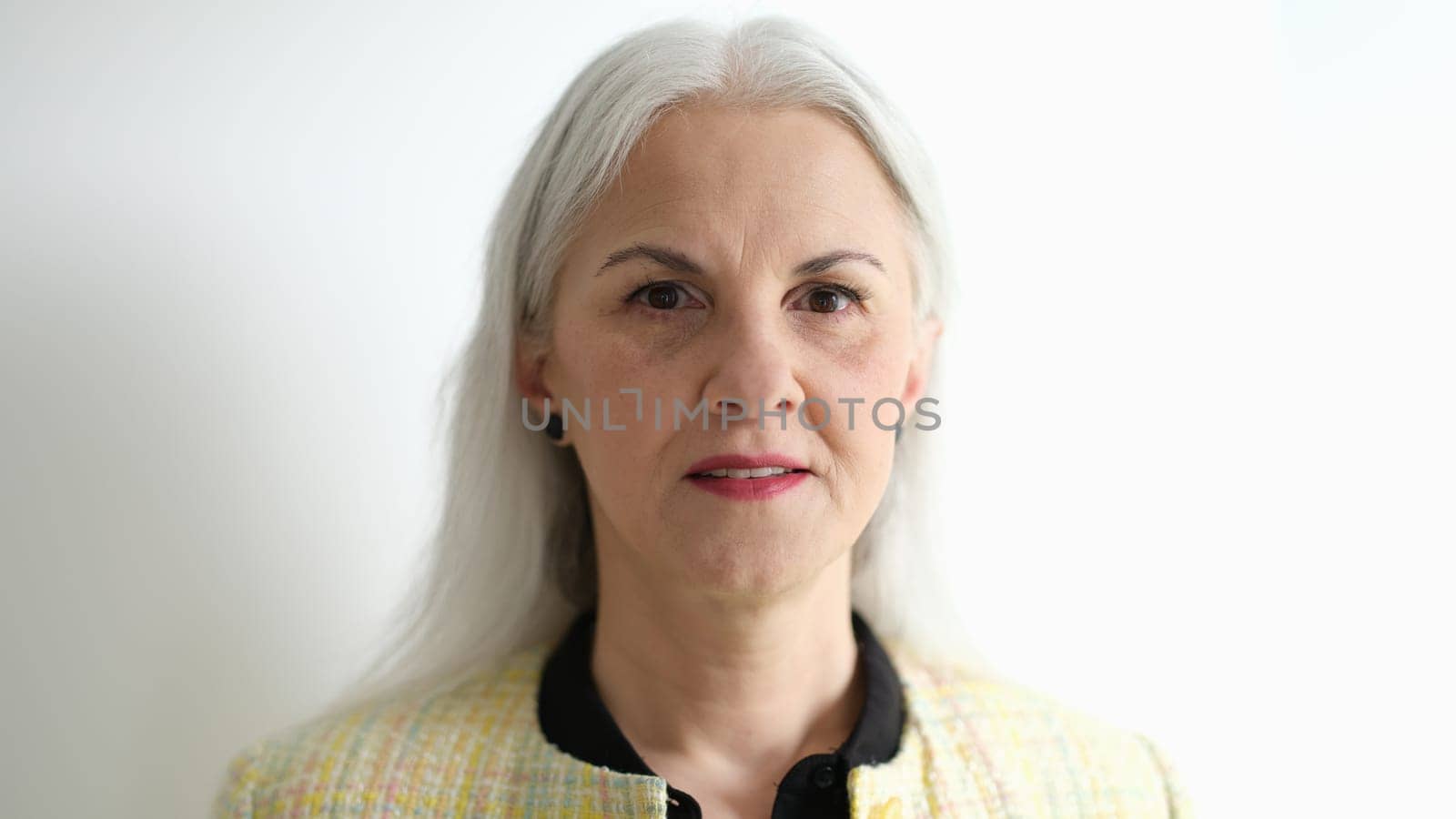 Portrait of elderly woman with long gray hair on white background by kuprevich