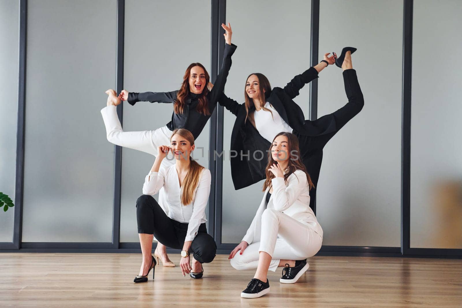 Group of adult women that in formal clothes is indoors in the office together by Standret