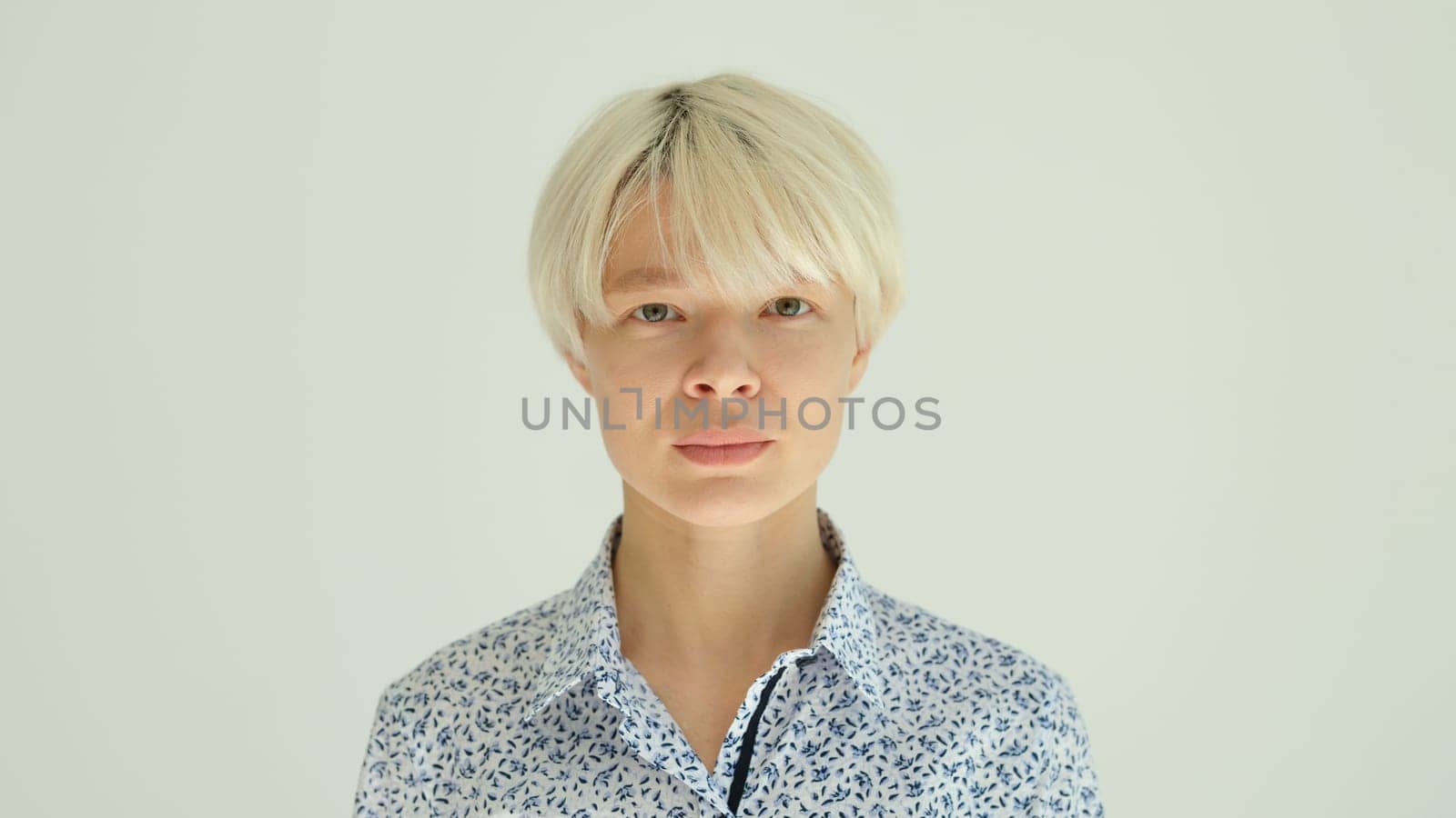 Portrait of blonde woman with short hair on white background. Stylish hairstyle concept
