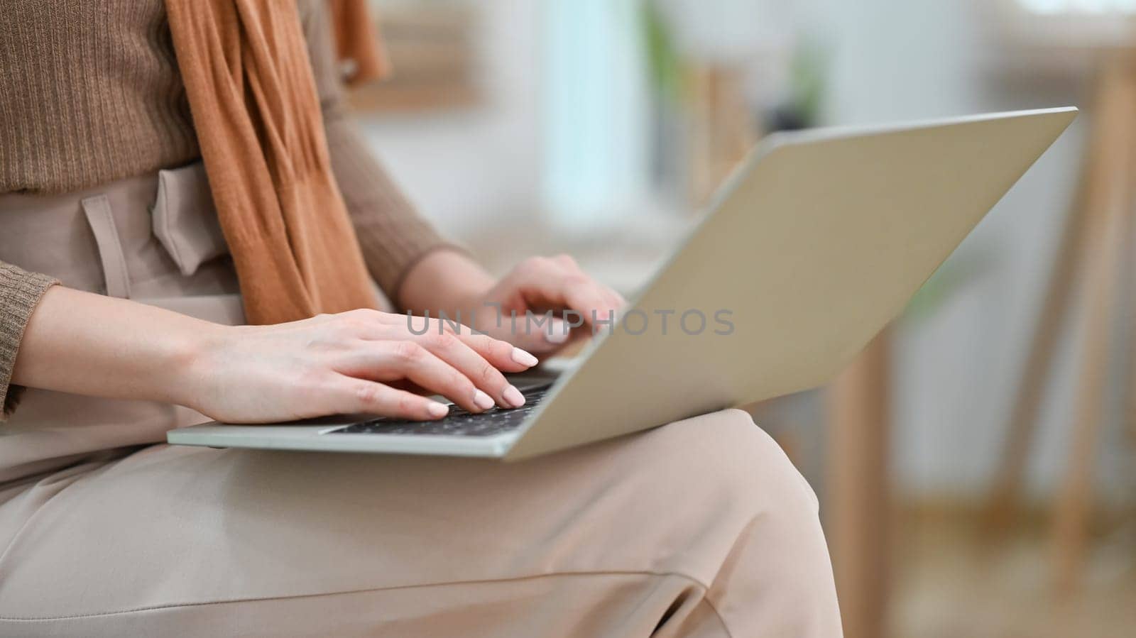 Cropped image of woman hands typing on laptop computer, studying remotely or browsing internet by prathanchorruangsak