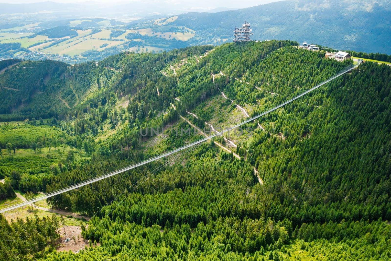 Sky Bridge 721 is the longest suspension bridge between two hills in the forest, Dolni Morava, Czech Republic . One way footbridge in touristic place in the forest in summer.