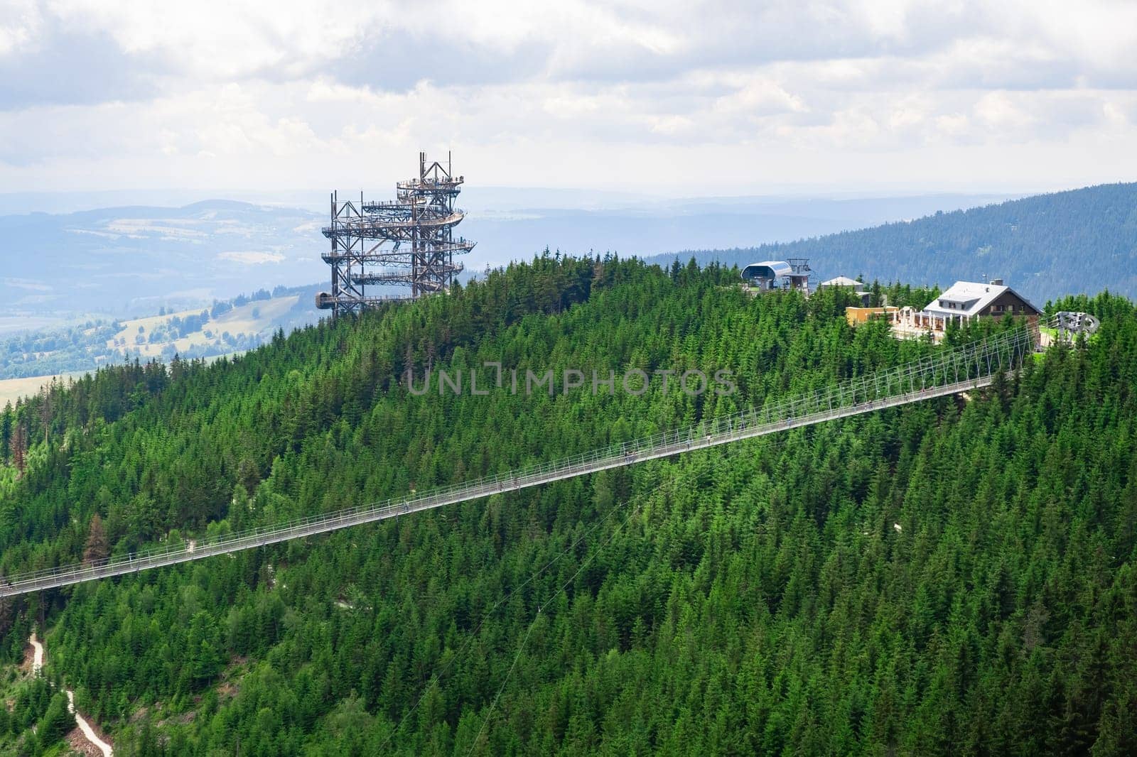 Sky walk observation tower in the forest between mountain hills near Sky Bridge 721 in a sunny summer day, Dolni Morava, Czech Republic.
