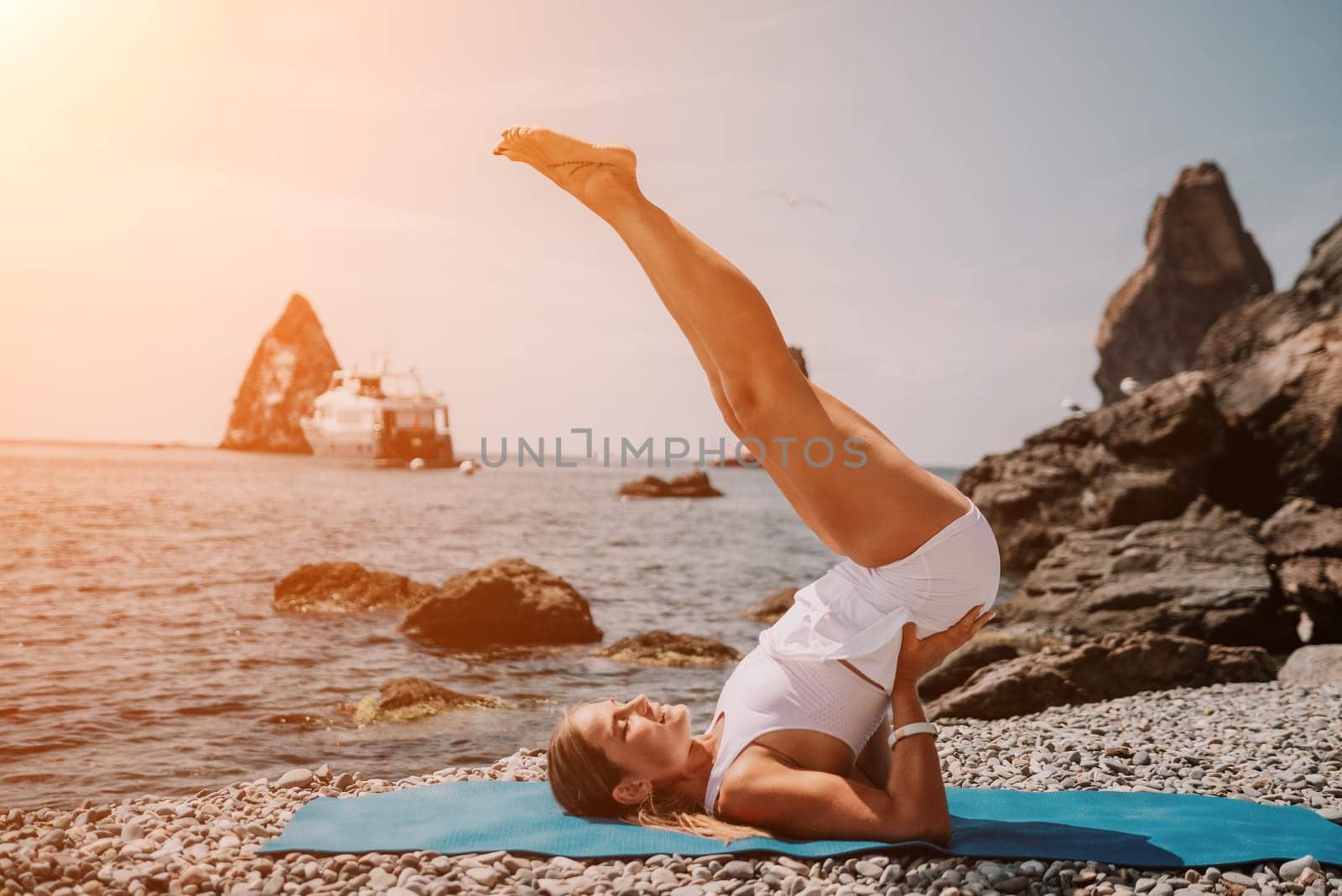 Woman sea yoga. Two Happy women meditating in yoga pose on the beach, ocean and rock mountains. Motivation and inspirational fit and exercising. Healthy lifestyle outdoors in nature, fitness concept. by panophotograph