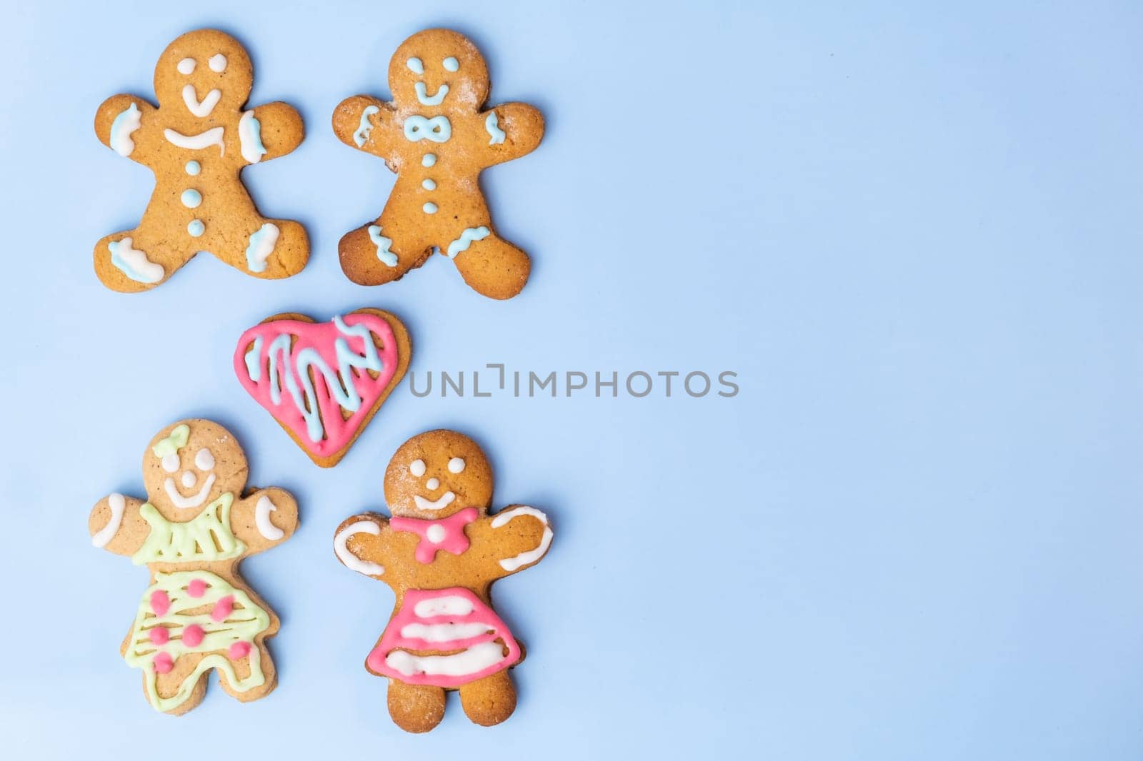 Homosexual couple cookies or gingerbreads and heart with colorful icing for St Valentines Day on the blue background with copy space by vladimka