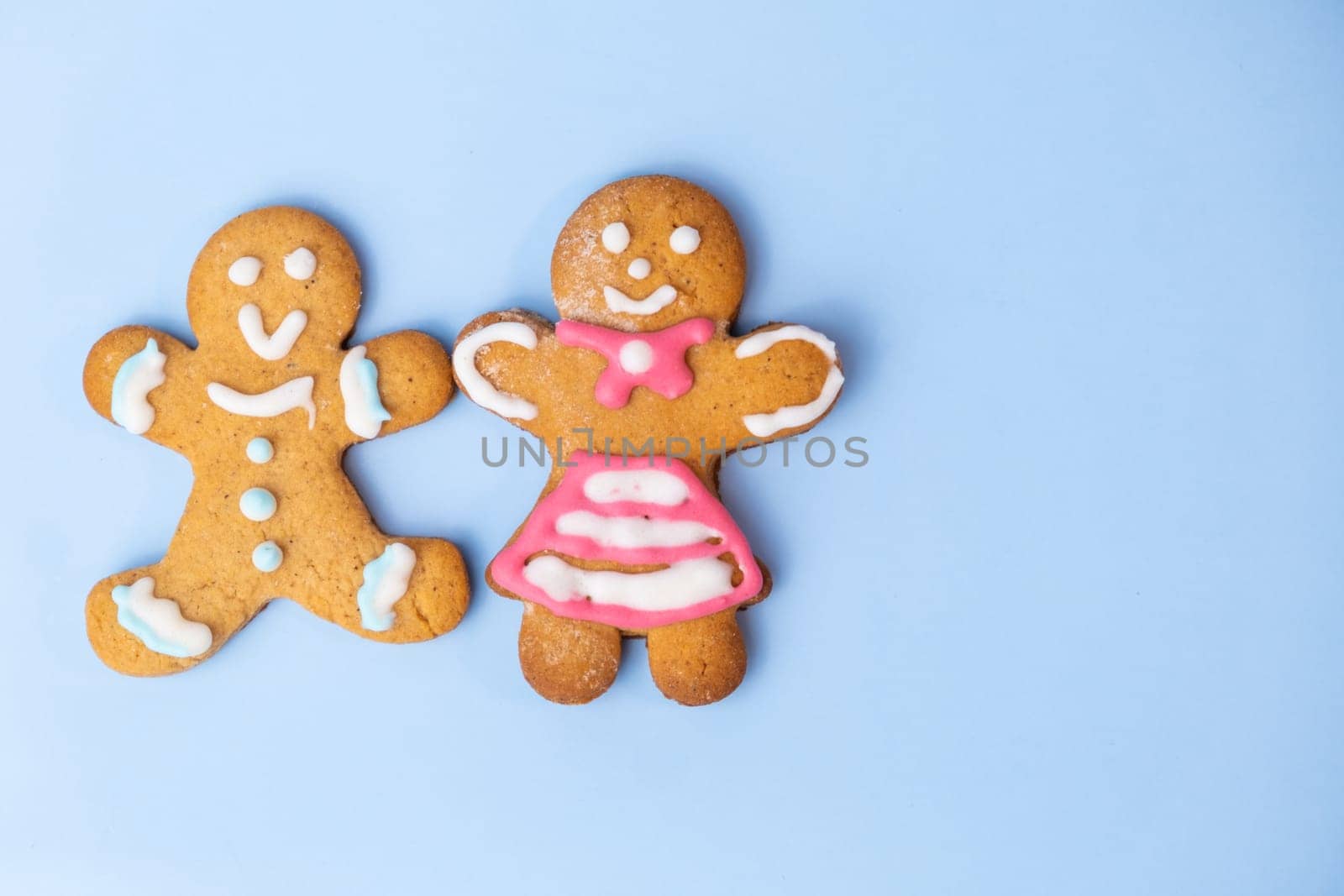 Boy and black girl gingerbread couplet on the blue background with copy space for St Valentines Day by vladimka