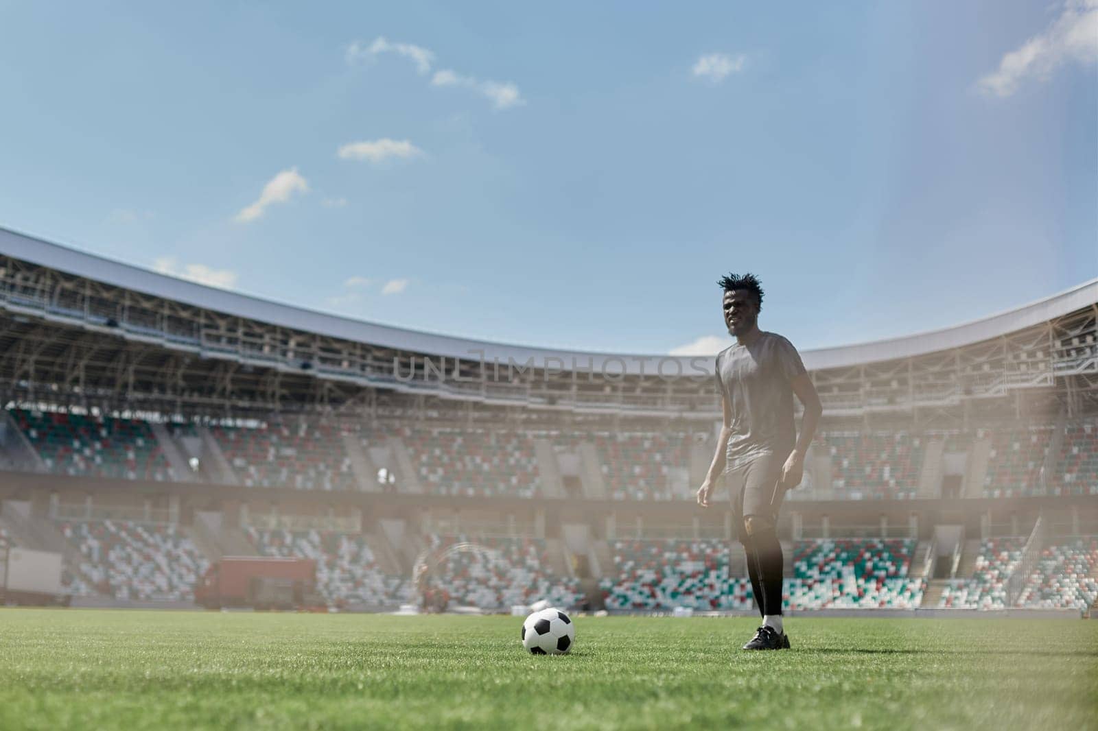 African American soccer player kicking ball during match