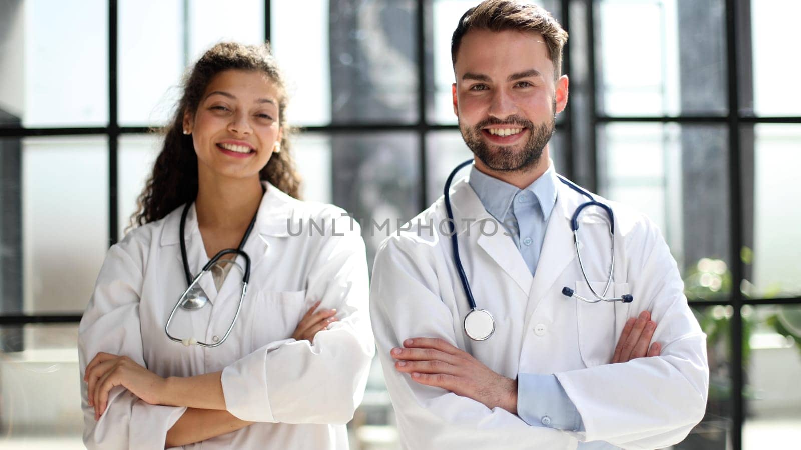 female doctor and male doctor stand in the lobby of the hospital