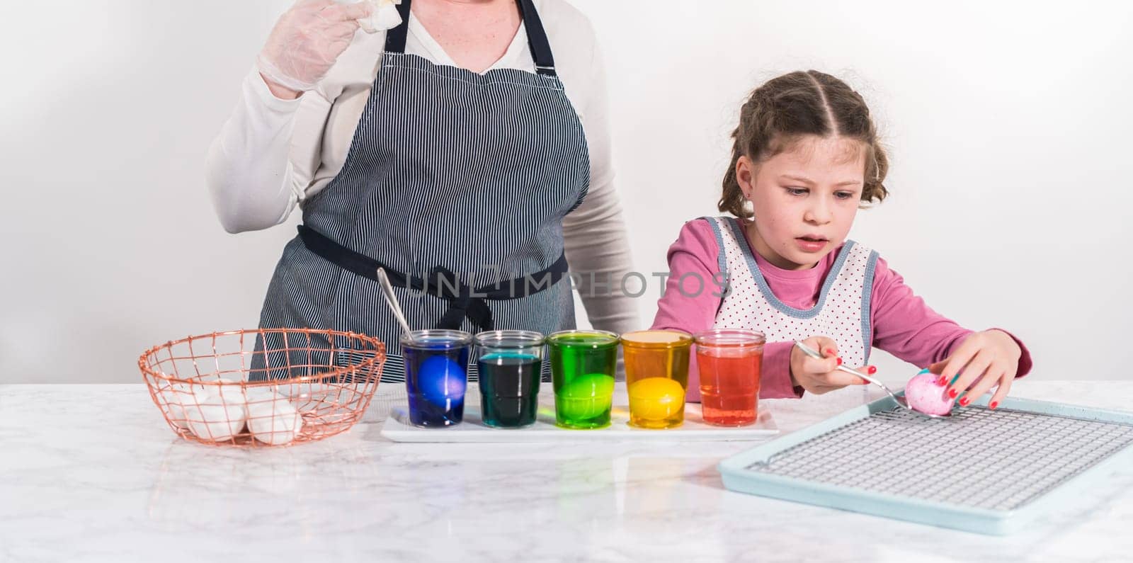 Easter egg coloring. Dye white organic eggs in different colors for Easter.