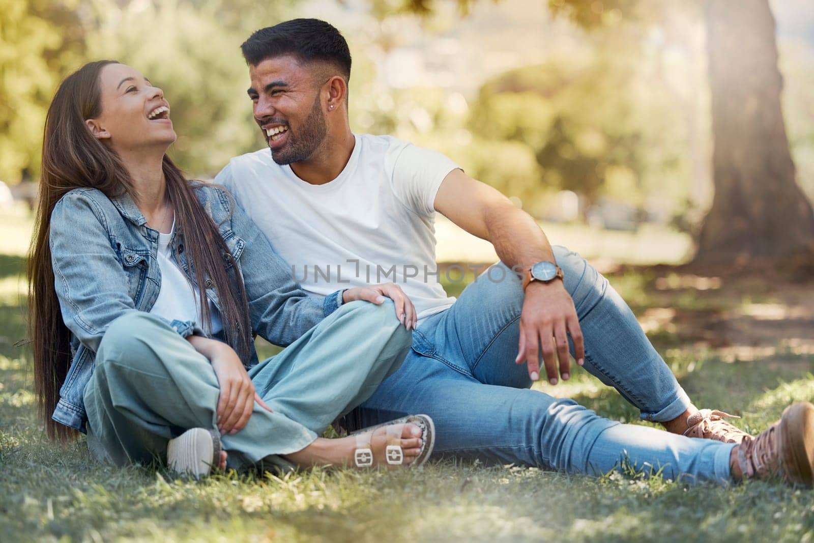 Couple are happy outdoor, laughing and relax together, love and care with trust in relationship and commitment. Happiness, support and freedom with man and woman in park with romance and bonding.