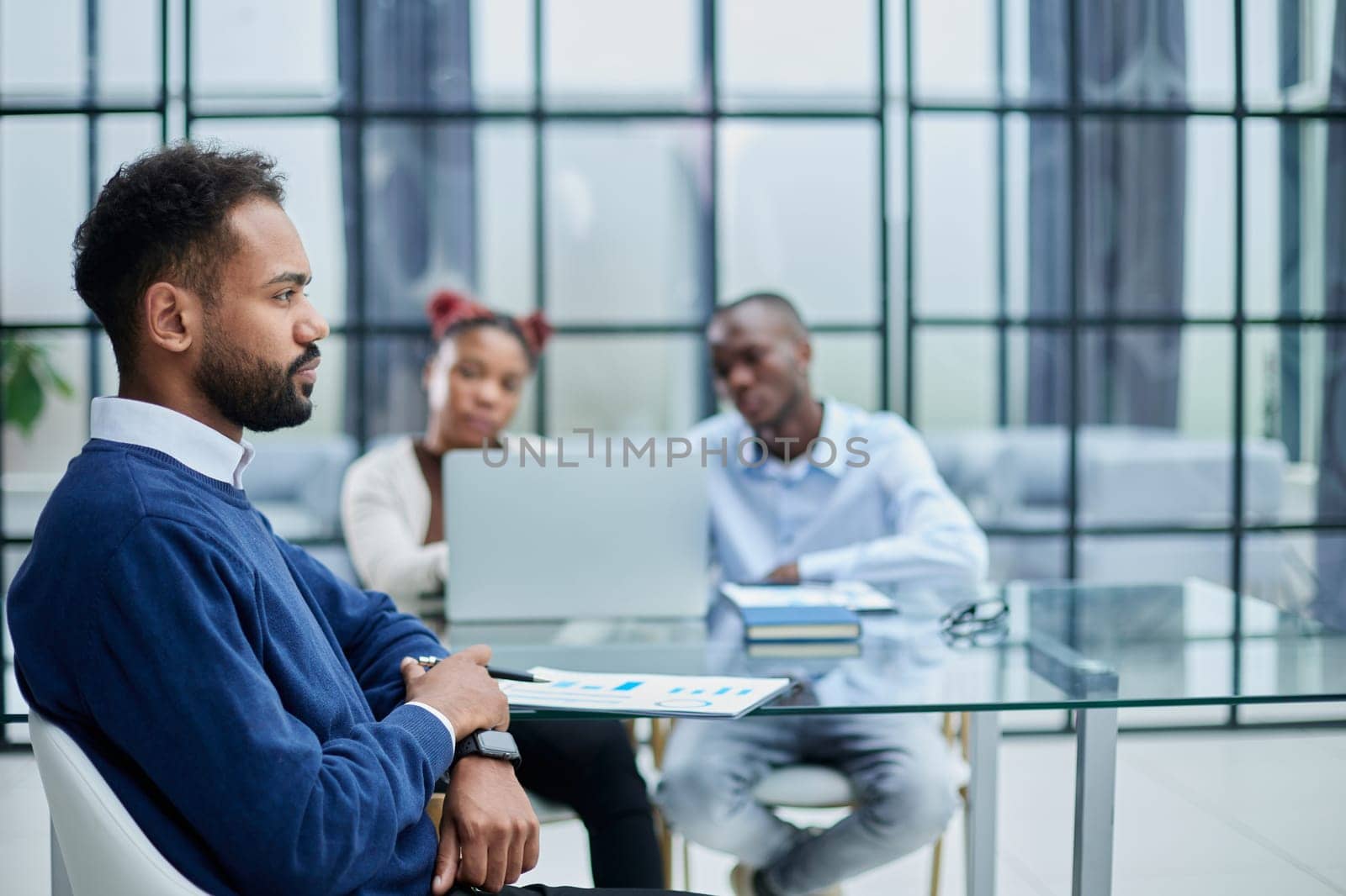 Portrait of African American businessman sitting at desk in an office