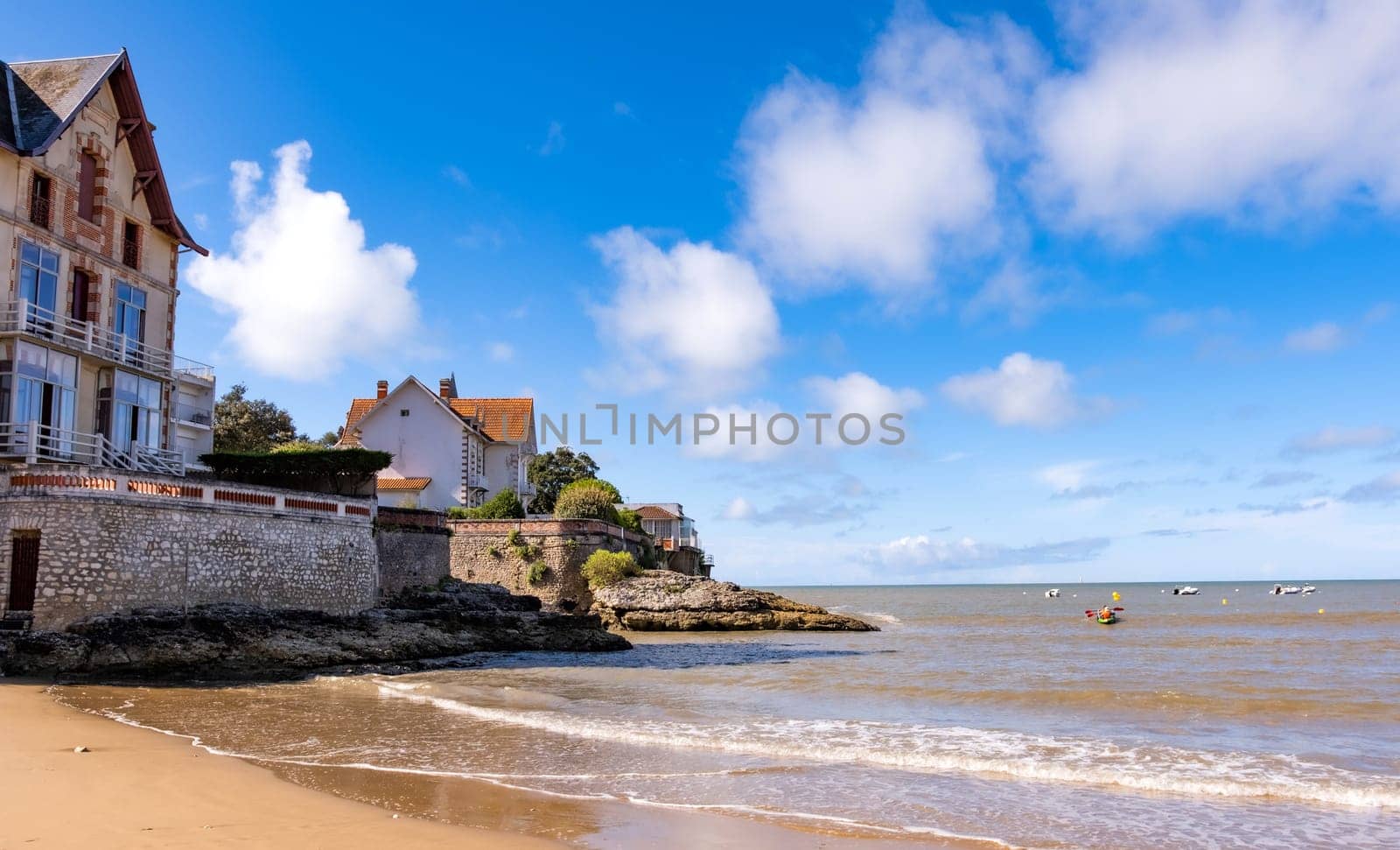 Beautiful house on sea coast with scenic view on ocean and sky. Beach vacation building on seashore