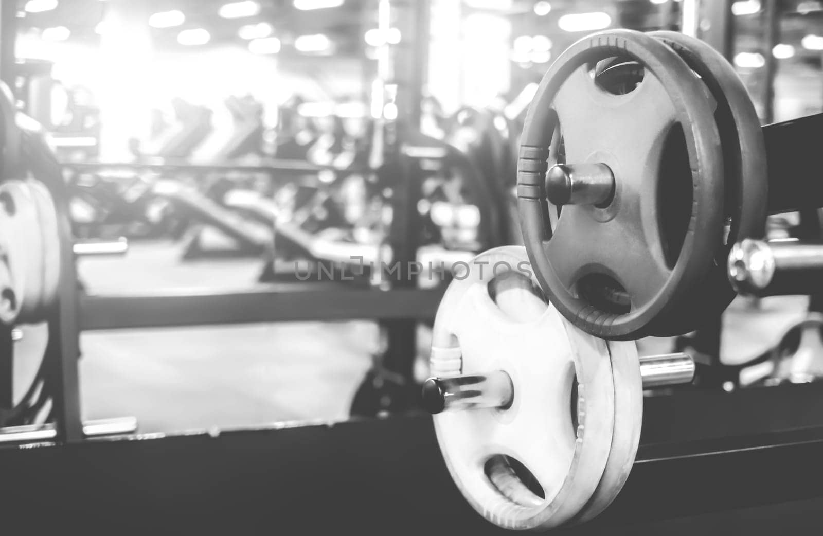 rack with differen weights in a modern gym, black and white shot