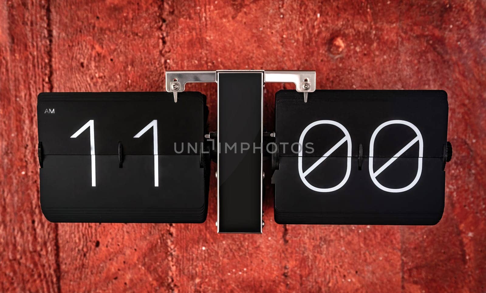 Flip black clock with eleven o'clock time on panel closeup by GekaSkr