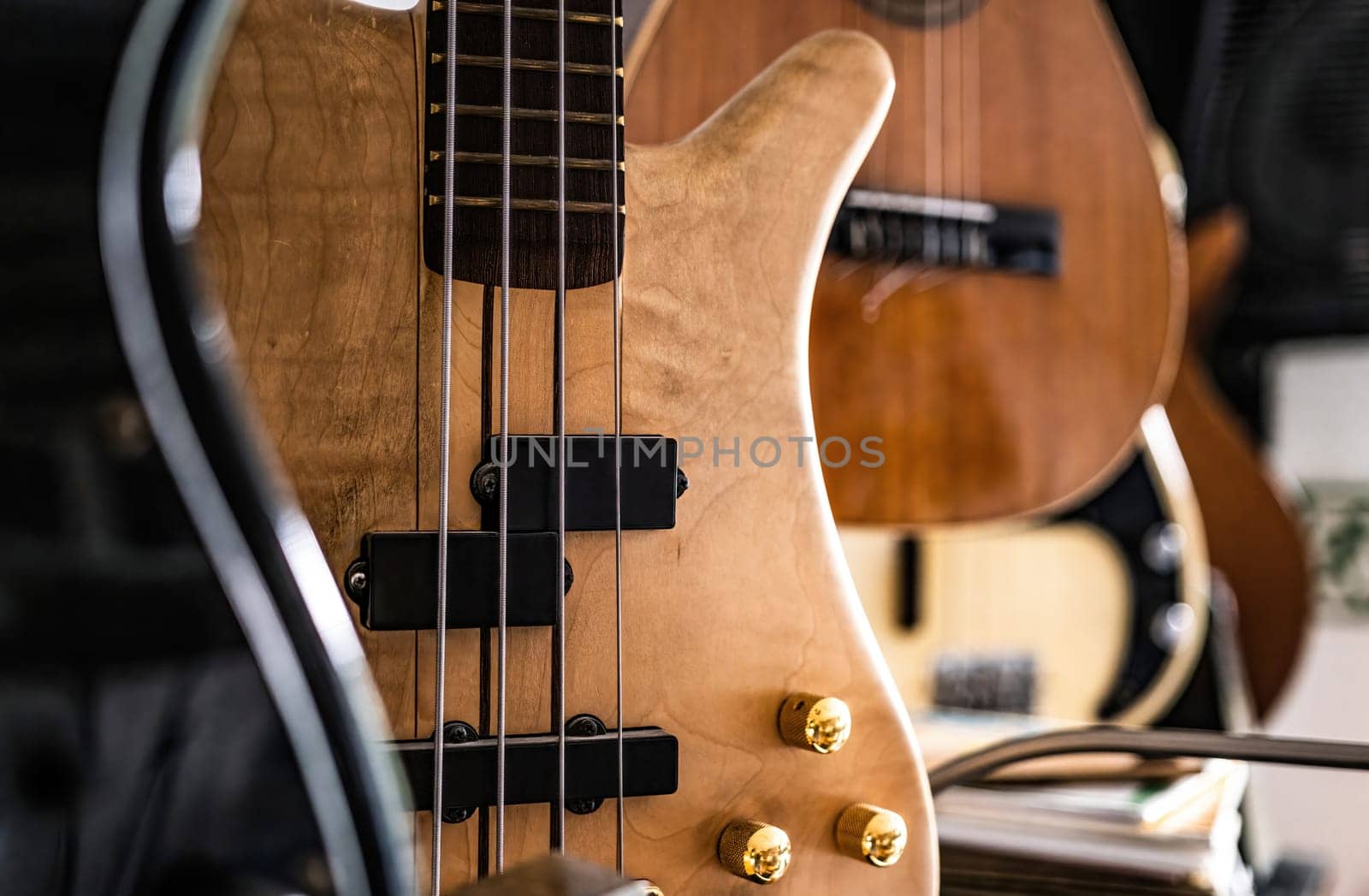 Bass guitar fretboardsand strings in music recording studio closeup. Musical instrument for live acoustic pop and rock perfomance