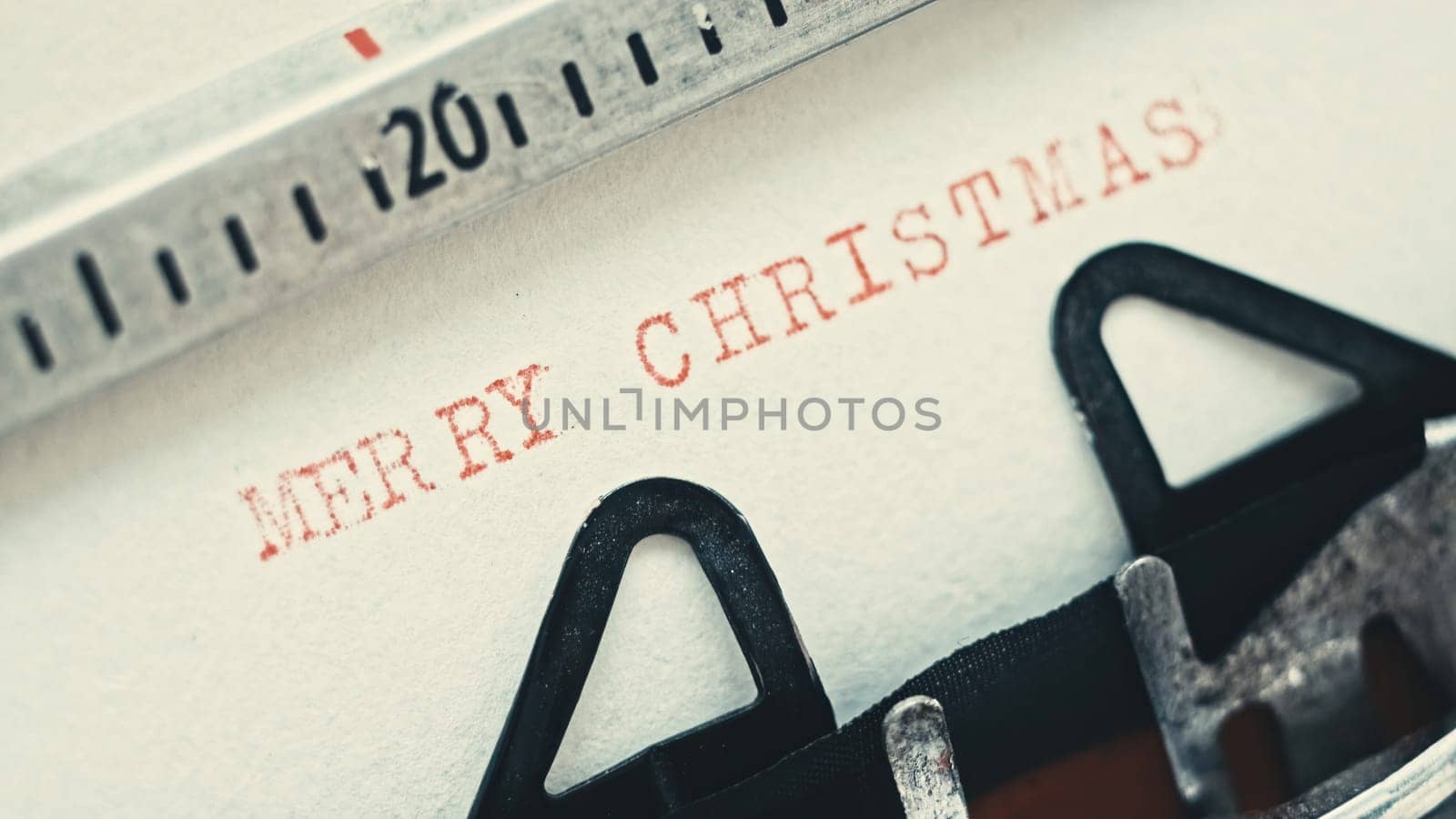 Vintage typewriter typing text Merry Christmas, close up view