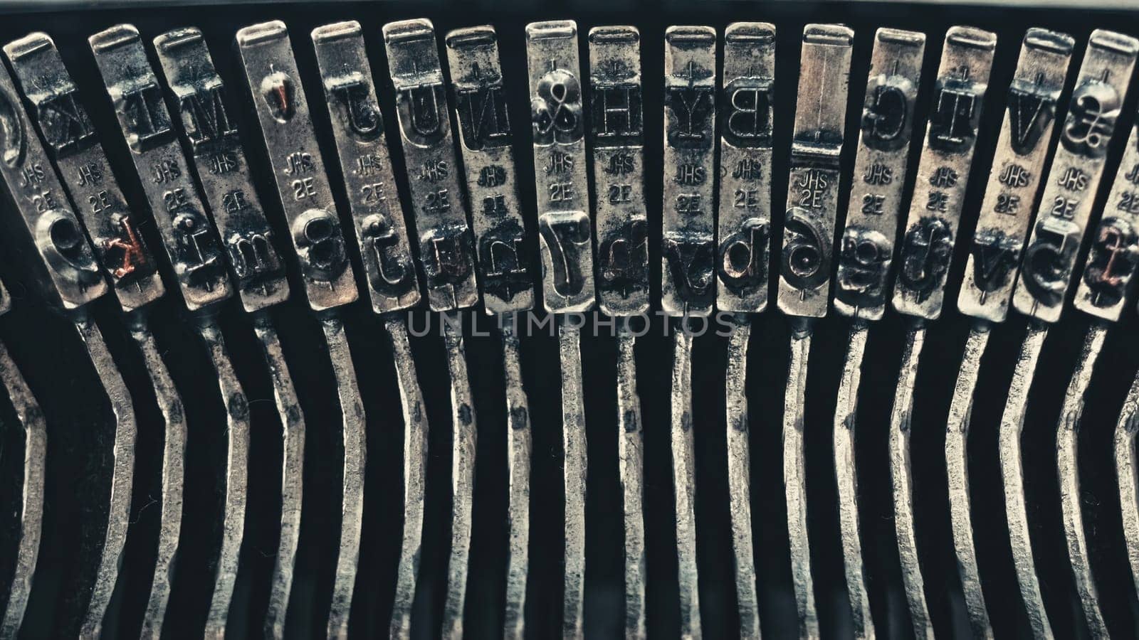 Letters and numbers on typo keys of an old manual typewriter on a retro writing machine, close up view