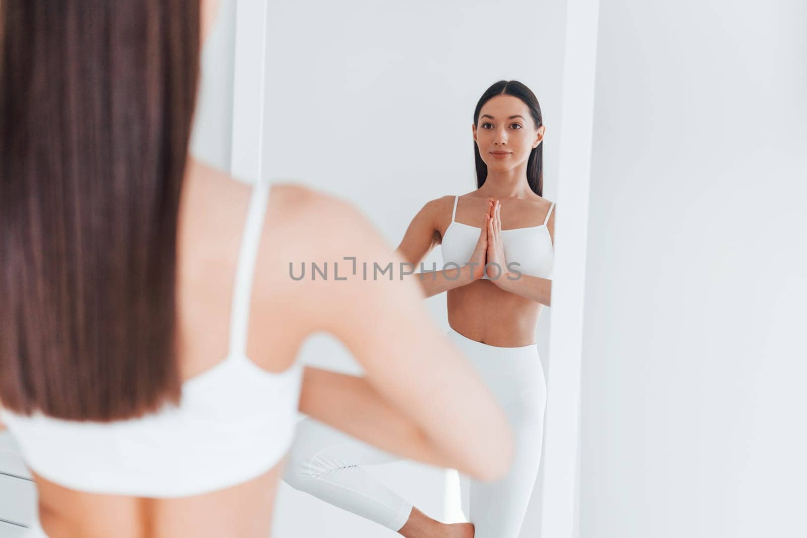 Young caucasian woman with slim body shape is indoors at daytime.