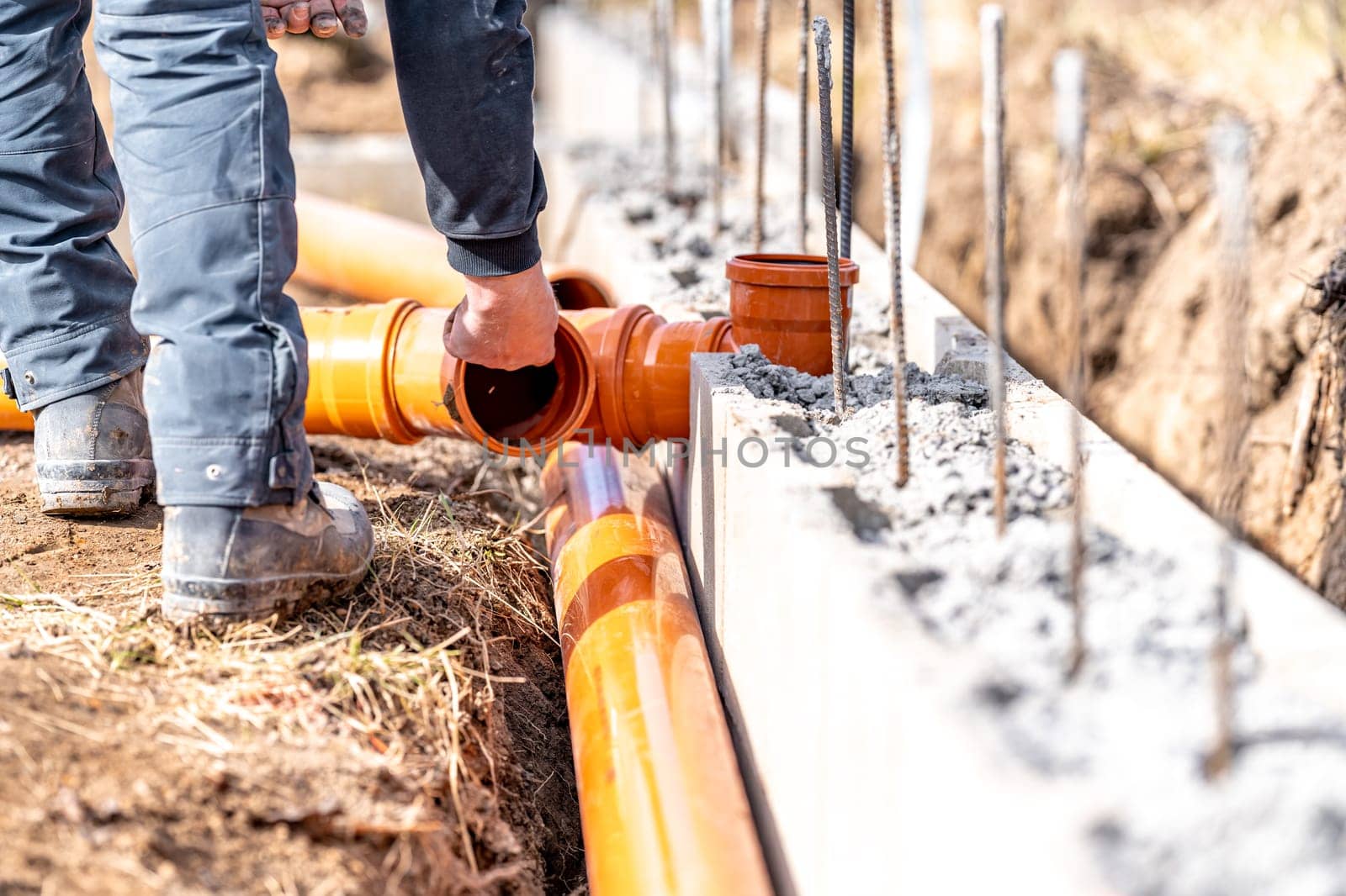 installation of a sewage plastic pipe during the construction of a house.