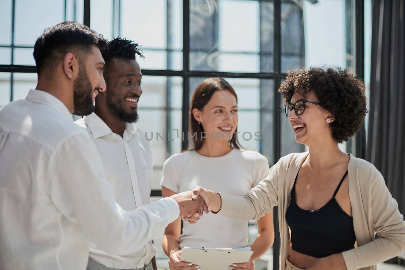 Employees working at computer together, discussing content by Prosto