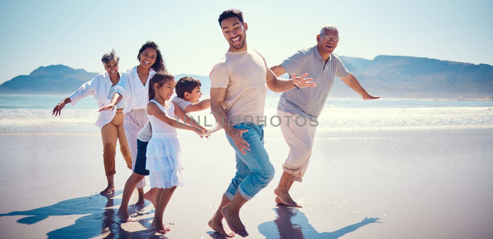Beach, family playing and running together on holiday, generations walking on ocean sand. Fun, vacation and happy men, women and kids bonding, quality time and summer adventure in nature in Mexico. by YuriArcurs