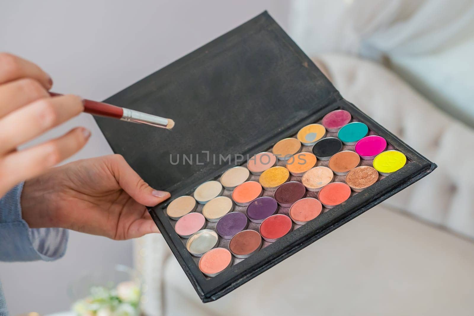 Makeup powder in the hands of a makeup artist