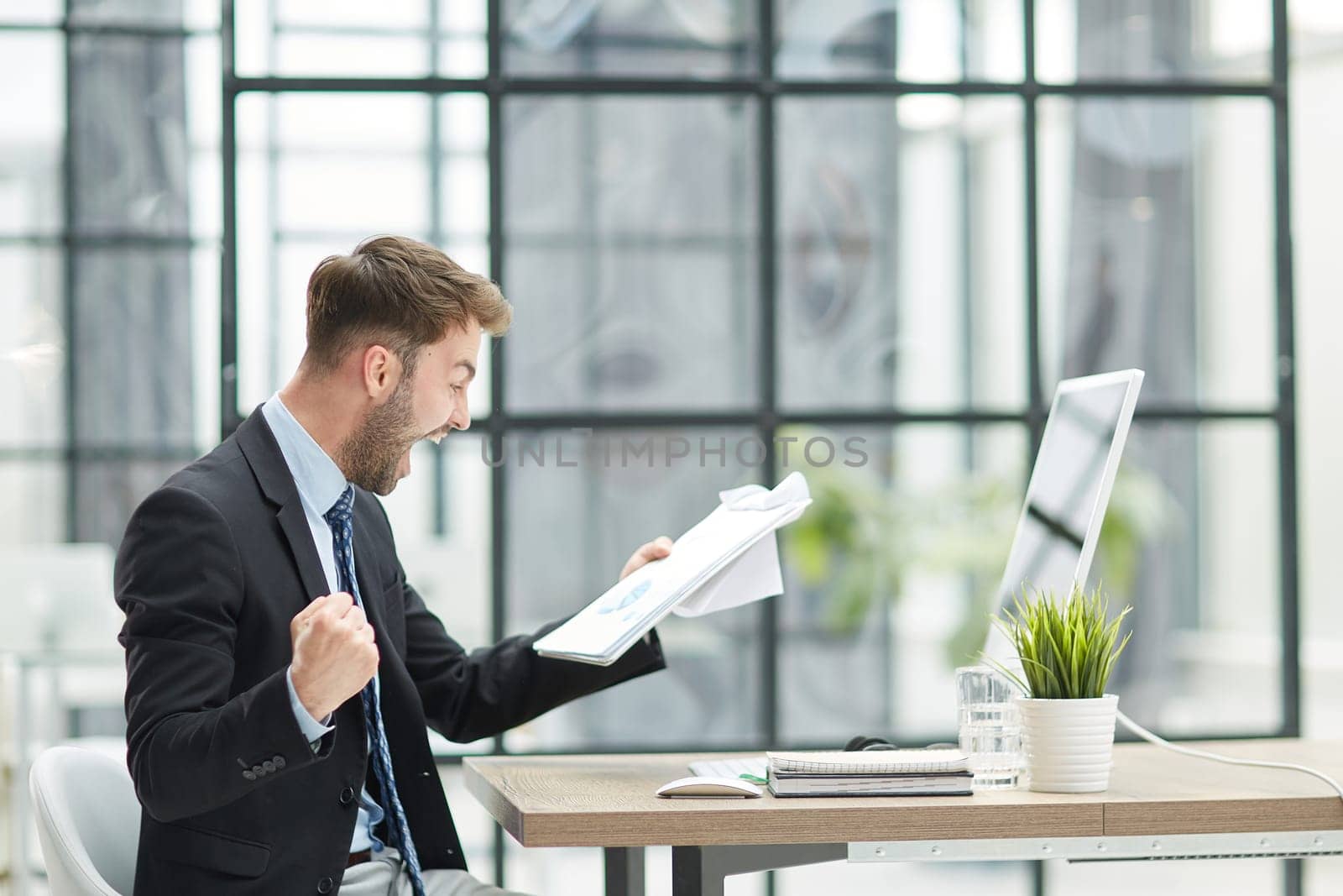 energetic businessman celebrating in office
