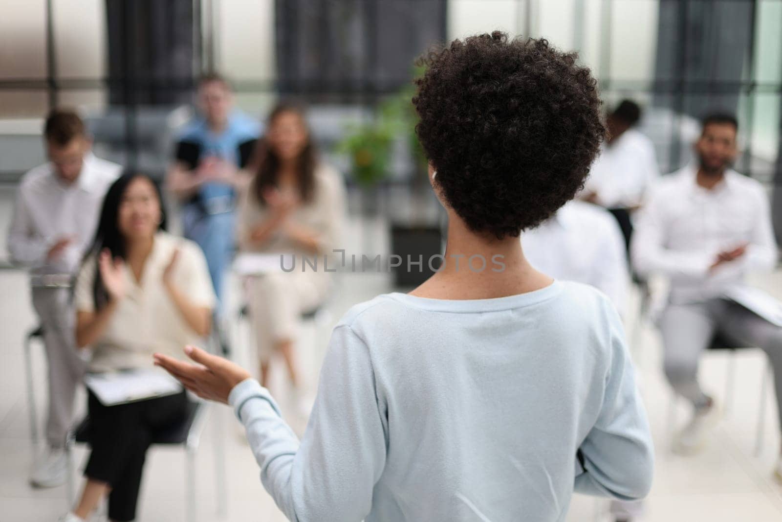 Selective focus of young businesswoman together with interracial colleagues during seminar