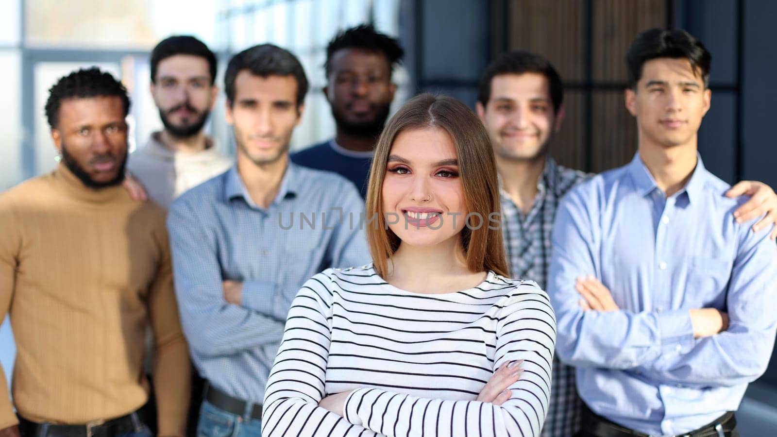 A group of young people stand and smile in a row