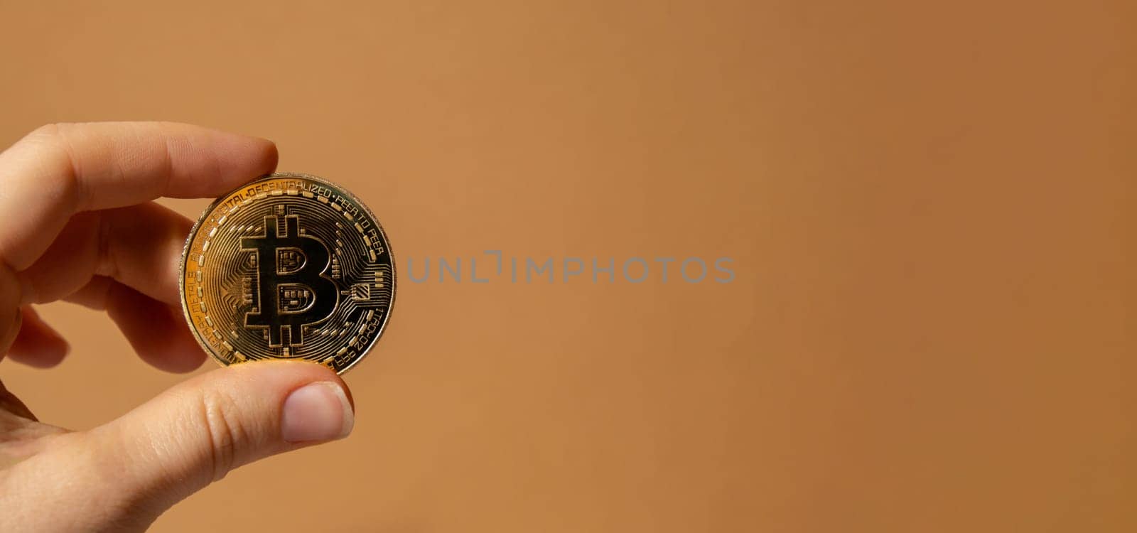 Female hands holding Bitcoin gold coin. Bitcoin mining trading concept. BTC golden money spinning around. Worldwide virtual internet Cryptocurrency or crypto digital payment system. Digital coin money farm in digital cyberspace