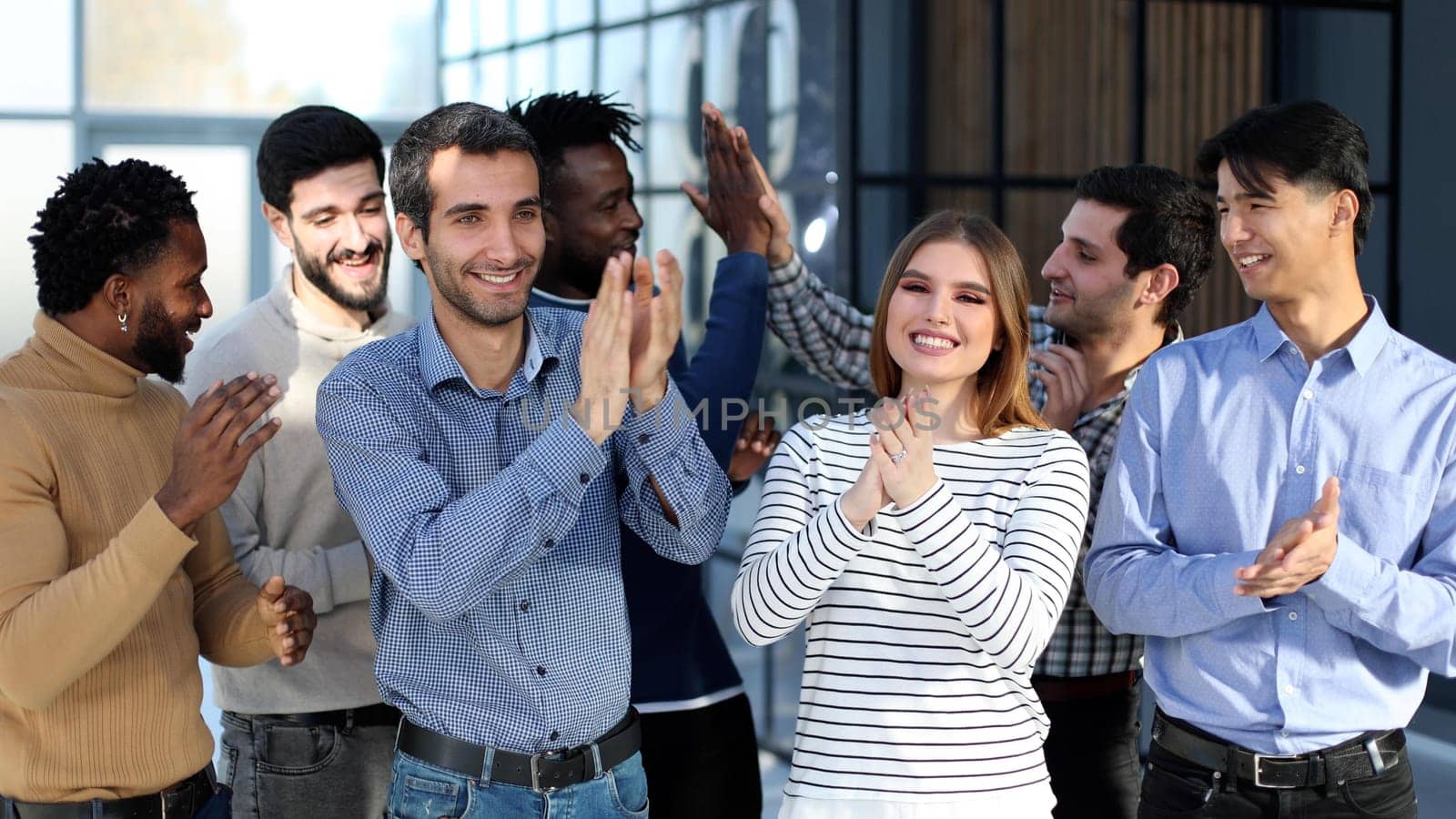 happy excited millennial employees shouting for joy, raising hands for emotional high fives.