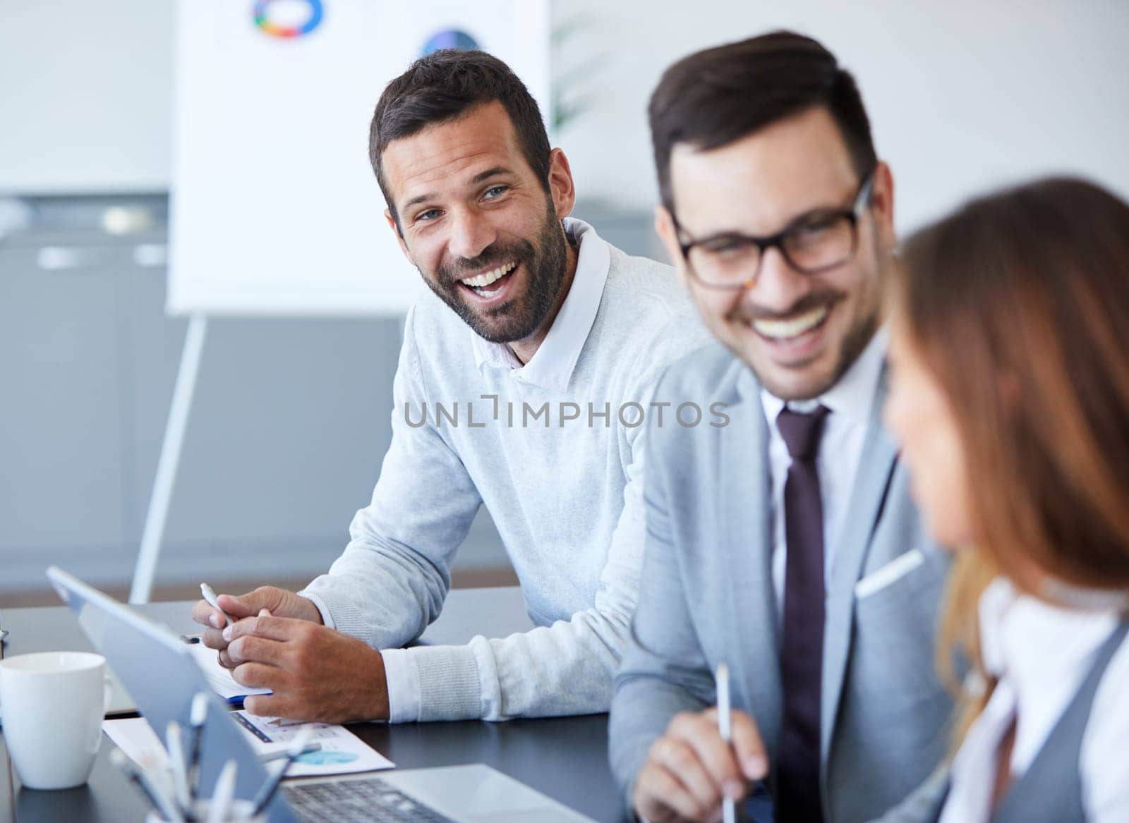 A portrait of a young smiling businessman a meeting and presentation in the office. Business concept