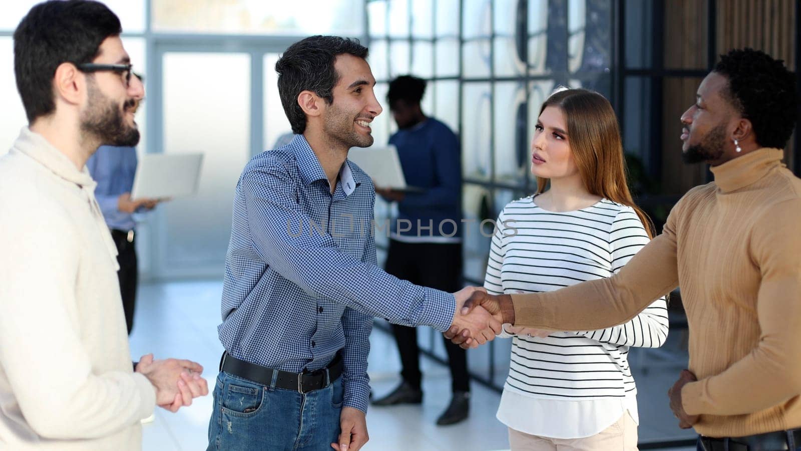 business coach shaking hands with a seminar participant by Prosto