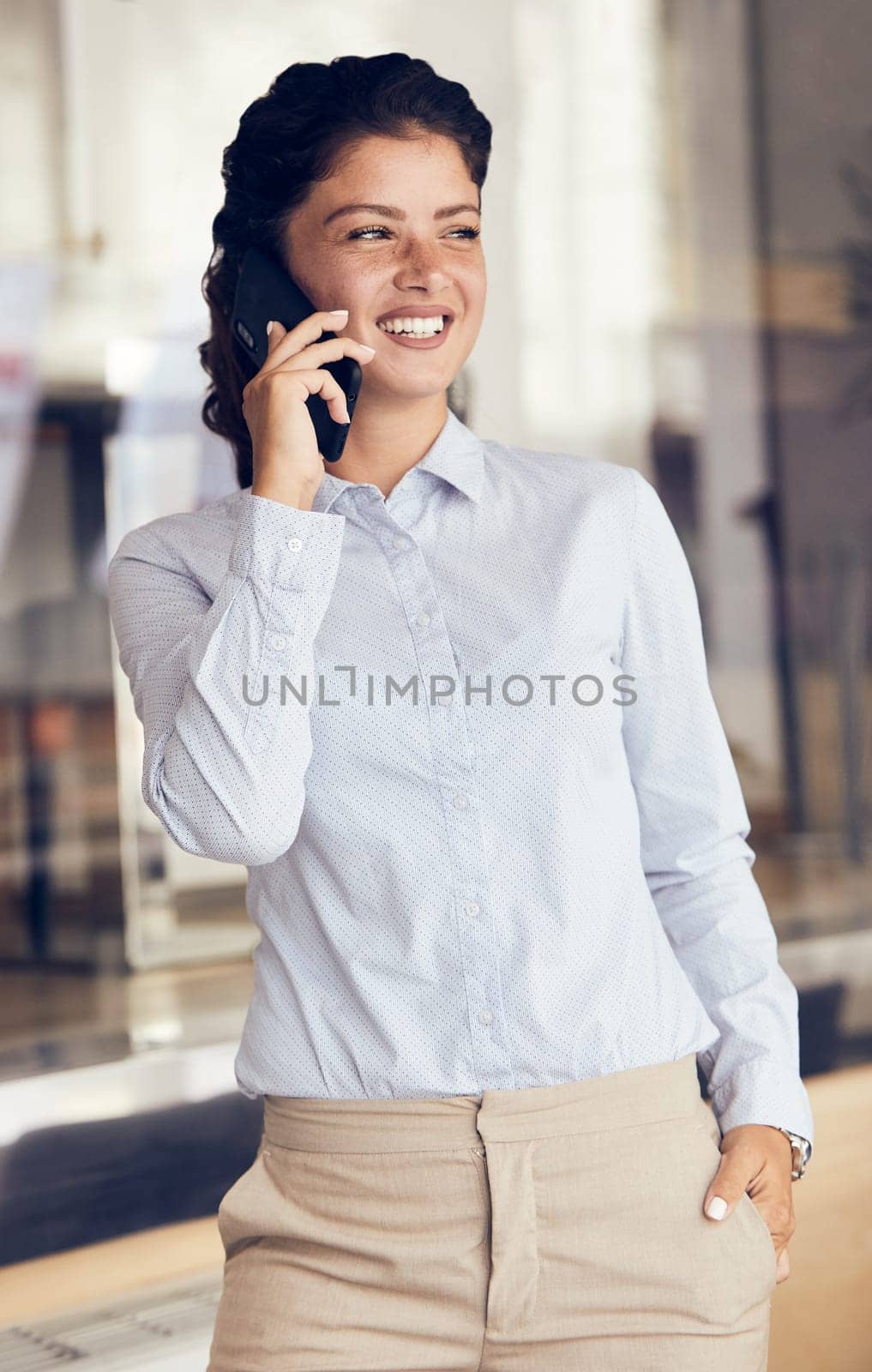 portrait of a smiling happy young girl talking on a cell phone. A business woman talking on the phone